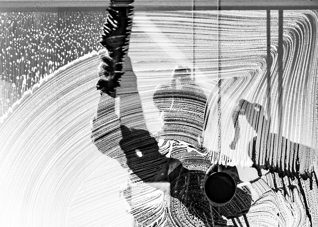 Crafting Captivating Headlines: Your awesome post title goes here Black and white photo of a window washer at work, captured in Buenos Aires, showcasing urban life and reflections.