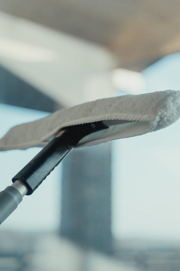 The Art of Drawing Readers In: Your attractive post title goes here Close-up of a cleaning tool on a window showcasing maintenance and sanitation.